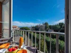 a balcony with a table with fruit on it at Apartment Porto Cristo by Interhome in Saint-Cyprien-Plage