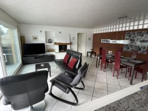a living room with a table and chairs at Holiday Home Seestern direkt am See by Interhome in Ennetbürgen
