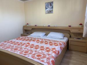 a bedroom with a bed with a floral bedspread at Apartment Old Hüsung - MUZ324 by Interhome in Mirow