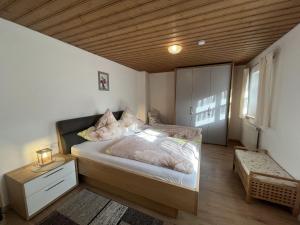 a bedroom with a bed and a wooden ceiling at Holiday Home Billerhof by Interhome in Zachenberg