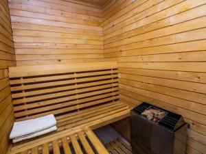 a sauna with a bench and a stove in it at Holiday Home Křečovice by Interhome in Rovensko pod Troskami