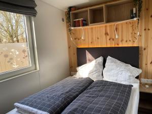 a bed in a room with a window at Holiday Home Tiny Haus Motte by Interhome in Wemding