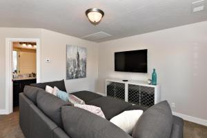 a living room with a couch and a flat screen tv at The View At The Escapes in St. George