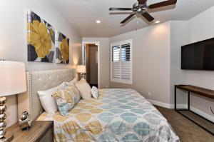 a bedroom with a bed and a flat screen tv at The View At The Escapes in St. George +31 photos