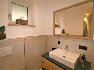a bathroom with a sink and a mirror at Apartment Christine by Interhome in Brixlegg