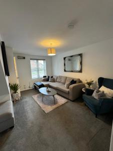a living room with a couch and a table at Church View 2 King Bedroom Contractor Family Sky TV in Higham Ferrers