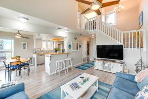 a living room and kitchen with a couch and a table at Waterfront Mustang Island Condo with Dock! in Corpus Christi