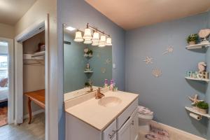 a bathroom with a sink and a mirror at Waterfront Mustang Island Condo with Dock! in Corpus Christi +22 photos