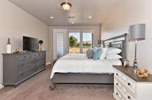 a bedroom with a bed with a television and a dresser at Luxury At The Ledges in St. George +35 photos