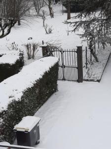 a trash can in the snow next to a fence at Goutanou 01200 in Châtillon-de-Michaille