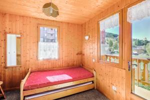 Bett in einem Zimmer mit 2 Fenstern in der Unterkunft Chalet le Séchet - Maeva Particuliers - 2 pièces 4 Personnes Confort 140621 in Bellentre