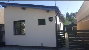 a white building with a blue roof at Tata Vendégház in Tata