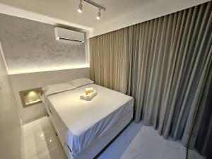 1 dormitorio con 1 cama con 2 toallas en SAINT TROPEZ BLOCO G APT 205 · Apartamento novo e reformado, Sudoeste QMSW 05, en Brasilia