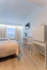 a hotel room with a bed and a large window at Hotel Kemijärvi in Kemijärvi