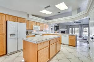a large kitchen with wooden cabinets and white appliances at Inviting Home with Lake View 2 Mi to Lake Havasu! in Lake Havasu City