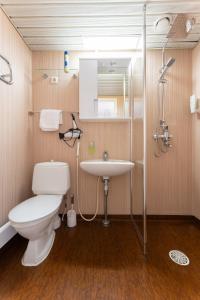 a bathroom with a toilet and a sink at Hotel Kemijärvi in Kemijärvi