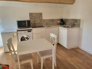 a kitchen with a table and a washing machine at Top studio + Parking + Wifi in Toulon