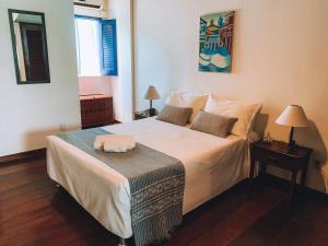 a bedroom with a large white bed in a room at Pousada Beija Flor in Salvador