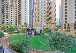 a park with a gazebo in the middle of a city at Spacious Studio in Murjan 2: Near the Beach in Dubai