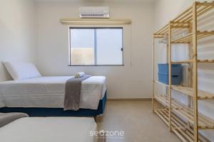 a bedroom with a bunk bed and a window at Aconchegante apartamento bem mobiliado PDM005 in Porto Seguro +28 photos