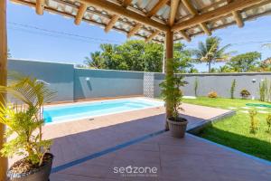 a swimming pool in the backyard of a villa at Aconchegante apartamento bem mobiliado PDM005 in Porto Seguro
