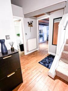 a living room with a staircase and a hallway at Modern Apartment, Nottingham City Centre, With Parking! Sleeps 4 in Nottingham