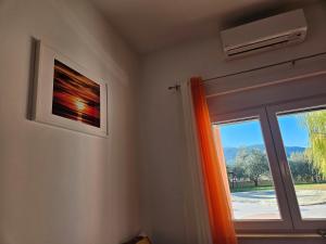 Habitación con ventana con cortina naranja en Villa Fabry, en Ploče