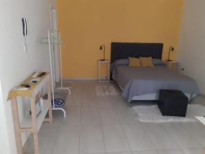 a bedroom with a bed and a table in it at Departamento El Olivo con cochera in Santa Rosa