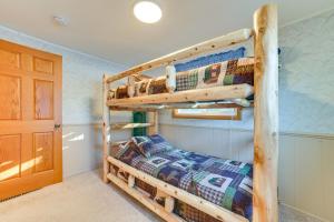a bedroom with two bunk beds and a door at Boyne City Retreat Near Beaches and Mtn Resort! in Boyne City