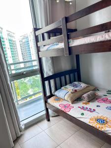 a bunk bed in a room with a window at Azure Staycation Suites by MECS in Manila