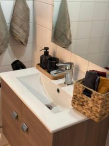 a bathroom sink with a soap dispenser on it at Central Square Studio in Xanthi