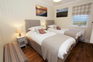 En eller flere senge i et værelse på Taigh Gorm