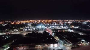 a view of a city at night with lights at Unidade Ravena - Centro in Ribeirão Preto