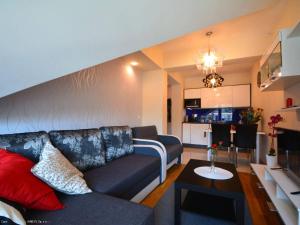 a living room with a couch and a table at Apartament Pod Giewontem in Zakopane