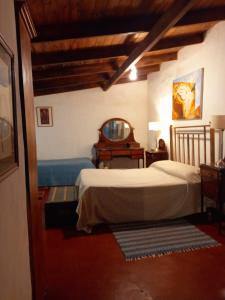 a bedroom with two beds and a mirror at Hotel Posada El Recodo in Villa del Totoral