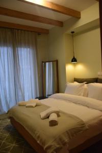 a bedroom with two beds with towels on it at TheAretsouPlace, Kalamaria in Thessaloniki