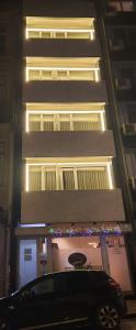 a car parked in front of a building with christmas lights at Apartamentos Portodouro - Santa Catarina in Porto