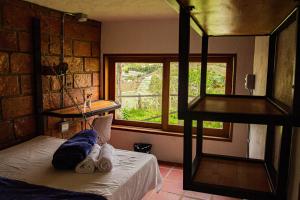 a baby laying on a bed in a room with a window at Riverside Ecoliving Space in Jericó