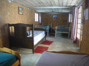 a bedroom with two beds in a room with windows at wagons dortoir in Chaudenay