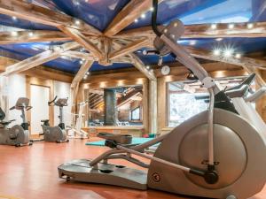 a gym with treadmills and elliptical machines at Résidence Les Fermes de Méribel - maeva Home - Appartement pièces Prestige 74 in Les Allues