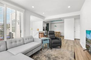 a living room with a couch and a table at Modern & Uncluttered - A Ryson Property in Palm Springs