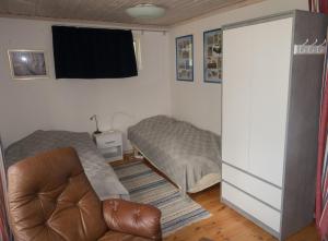 uma sala de estar com um sofá e uma cama em Kallrigafjärden nära Öregrund em Östhammar
