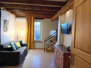 a living room with a couch and a tv at La porte chamarrée... in Saint-Nicolas-de-la-Grave