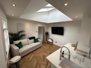 a living room with a couch and a tv at Apartment in Barnard Castle in Barnard Castle