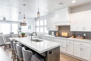 a kitchen with white cabinets and a kitchen island at Live All In in St. George