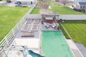 an aerial view of a backyard with a pool at 6 King Bedrooms, Sleeps 20, 8 Rooms, Bikes, HotTub in Lindon