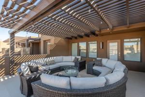 an outdoor living room with couches and a table at Live All In in St. George