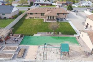 an aerial view of a backyard with a swimming pool at 6 King Bedrooms, Sleeps 20, 8 Rooms, Bikes, HotTub in Lindon