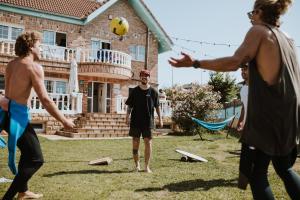 a group of men playing a game of frisbee at Gijon Surf Hostel in Gijón