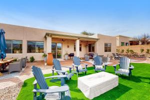 a patio with chairs and a table and a table and chairs at Pink Mountain Retreat in Tucson
